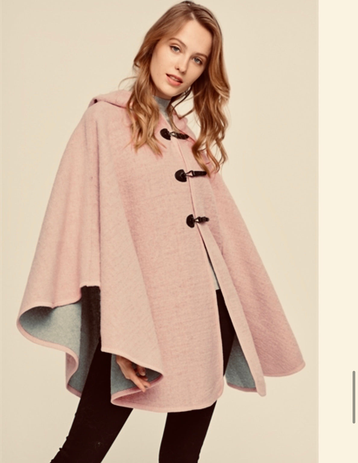 Creamed pink hooded poncho with 3 snap closure